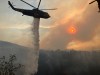An aerial firefighting crew drops water from a helicopter on the Bald Range wildfire near Summerland, B.C., in this Monday, Aug. 10, 2026, handout photo. THE CANADIAN PRESS/Handout — B.C. Wildfire Service (Mandatory Credit)
