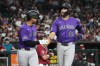 Colorado Rockies' Kyle Karros (12) celebrates with Ezequiel Tovar after hitting a two-run home run against the Arizona Diamondbacks in the first inning of a baseball game, Tuesday, Aug 11, 2026, in Phoenix. (AP Photo/Rick Scuteri)