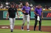 Colorado Rockies' Kyle Karros (12) leaves the game after colliding with Ezequiel Tovar on a ball hit by Arizona Diamondbacks' Ketel Marte in the sixth inning of a baseball game, Tuesday, Aug 11, 2026, in Phoenix. (AP Photo/Rick Scuteri)