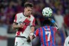 FILE -Rayo's Pep Chavarria and Crystal Palace's Ismaila Sarr jump for the ball during the Europa Conference League final soccer match between Crystal Palace and Rayo Vallecano in Leipzig, Germany, May 27, 2026. (AP Photo/Ebrahim Noroozi), File)