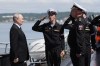 Russian President Vladimir Putin, left, visits the Varyag missile cruiser of the Pacific Fleet to watch a military exercise near Yuzhno-Sakhalinsk, on Sakhalin Island, Russia, Wednesday, Aug. 12, 2026. (Gavriil Grigorov, Sputnik, Kremlin Pool Photo via AP)
