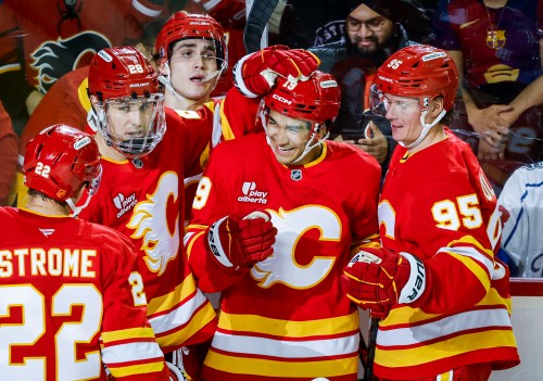 Calgary Flames' Zayne Parekh (19) celebrates his goal with teammates during third period NHL hockey action against the Los Angeles Kings in Calgary on Thursday, April 16, 2026.THE CANADIAN PRESS/Jeff McIntosh
