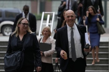 Attorney Paul W. Schmidt, representing Meta, right, arrives at a Federal Courthouse Wednesday, Aug. 12, 2026, in Oakland, Calif. (AP Photo/Jeff Chiu)