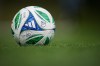 A soccer ball with the MLS logo and Commissioner Don Garber's signature sits on the pitch as the Vancouver Whitecaps practice, in Vancouver, on Wednesday, Oct. 22, 2025. THE CANADIAN PRESS/Darryl Dyck
