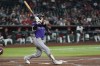 Colorado Rockies' Brett Sullivan watches the flight of his three-run home run against the Arizona Diamondbacks during the second inning of a baseball game, Wednesday, Aug. 12, 2026, in Phoenix. (AP Photo/Ross D. Franklin)
