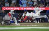 Blue Jays first baseman Vladimir Guerrero Jr. (27) scores a run past the tag of Boston Red Sox catcher Adley Rutschman (31) in Toronto on Wednesday, Aug. 12, 2026. THE CANADIAN PRESS/Nathan Denette
