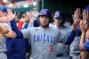 Chicago Cubs' Alex Bregman (3) is greeted in the dugout by teammates after scoring a run on a sacrifice fly hit by Nico Hoerner off of Washington Nationals pitcher Jake Irvin during the second inning of a baseball game in Washington, Tuesday, Aug 11, 2026. (AP Photo/Terrance Williams)