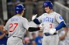 Chicago Cubs' Seiya Suzuki, left, greets Cubs' Alex Bregman at home plate after Bergman drove him in on a two-run home run during the eighth inning of a baseball game against the Washington Nationals, Wednesday, Aug. 12, 2026, in Washington. (AP Photo/John McDonnell)