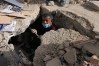FILE - Franklin Fuentes searches for missing relatives in the collapsed building where they lived two days after earthquakes struck La Guaira, Venezuela, June 26, 2026. (AP Photo/Ariana Cubillos, File)