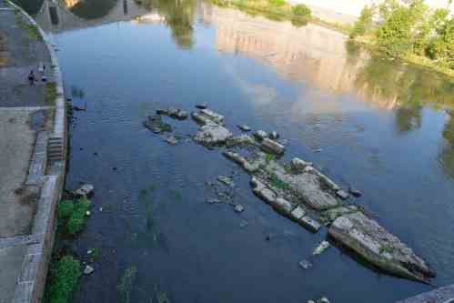 The ruins of the ancient Roman Neronian bridge, emerge from the riverbed of the Tiber river due to drought, in Rome, Thursday, Aug. 13, 2026. (AP Photo/Gregorio Borgia)