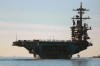 FILE - Sailors and marines line the deck of aircraft carrier USS Abraham Lincoln (CVN-72) as it deploys from San Diego,, Jan. 3, 2021. (K.C. Alfred/The San Diego Union-Tribune via AP, File)