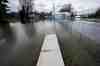 Floodwaters cover the sidewalk on Rue Saint-Louis in Gatineau, Que., on Sunday, April 19, 2026. THE CANADIAN PRESS/Justin Tang