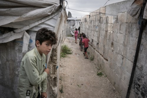Children play through al-Karama camp, established in the early years of the Syrian conflict, near the village of Atmeh, Idlib province, Syria, on May 19, 2026. (AP Photo/Omar Albam, File)