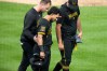Pittsburgh Pirates' Nick Gonzales, center, walks to first base with manger Don Kelly, right, and a team trainer, after being hit by a pitch from Boston Red Sox pitcher Jovani Morán during the fifth inning of a baseball game in Pittsburgh, Friday, Aug. 14, 2026. (AP Photo/Gene J. Puskar)