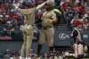 San Diego Padres' Jackson Merrill (3) congratulates Xander Bogaerts, center, after Bogaerts hit a two-run home run off Cleveland Guardians starting pitcher Gavin Williams during the fourth inning of a baseball game, Friday, Aug. 14, 2026, in Cleveland. (AP Photo/Phil Long)