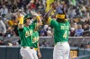 Athletics' Jeff McNeil, left, high-fives Lawrence Butler (4) after hitting a home run during the sixth inning of a baseball game against the Texas Rangers Friday, Aug. 14, 2026, in West Sacramento, Calif. (AP Photo/Sara Nevis)