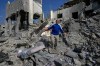 A man reacts on the rubble of a destroyed home that was hit by an Israeli airstrike in Ansar village, southern Lebanon, Saturday, Aug. 15, 2026. (AP Photo/Mohammed Zaatari)