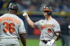 Baltimore Orioles' Tyler O'Neill (9) celebrates with first base coach Jason Bourgeois (36) after his RBI single off Tampa Bay Rays pitcher Bryan Baker during the 10th inning of a baseball game Saturday, Aug. 15, 2026, in St. Petersburg, Fla. (AP Photo/Chris O'Meara)