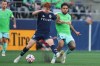 Vancouver Whitecaps midfielder Oliver Larraz, left, goes for the ball against Seattle Sounders forward Jesús Ferreira, right, during the first half of an MLS match, Sunday, Aug. 16, 2026, in Seattle. (AP Photo/Lindsey Wasson)