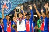 PSG's Maghnes Akliouche lifts the trophy during celebrations at the end of the UEFA Super Cup soccer match between Paris Saint-Germain and Aston Villa in Salzburg, Austria, Wednesday, Aug.12, 2026. (AP Photo/Darko Bandic)