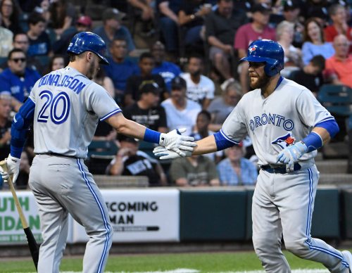 Blue Jays catcher Russell Martin, right, is greeted by teammate Josh Donaldson after hitting a home run against the White Sox in a Major League Baseball game on July 31, 2017, in Chicago. (AP Photo/David Banks)