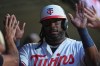 Minnesota Twins designated hitter Josh Bell celebrates in the dugout after scoring off a RBI single hit by Kody Clemens during the first inning of a baseball game against the Atlanta Braves, Monday, Aug. 17, 2026, in Minneapolis. (AP Photo/Abbie Parr)
