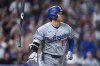 Los Angeles Dodgers' Shohei Ohtani tosses his bat as he heads up the first base line after hitting a two-run home run off Colorado Rockies relief pitcher Juan Mejia in the sixth inning of a baseball game Monday, Aug. 17, 2026, in Denver. (AP Photo/David Zalubowski)