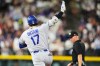 Los Angeles Dodgers' Shohei Ohtani (17) gestures to the bullpen as he circles the bases after hitting a two-run home run off Colorado Rockies relief pitcher Juan Mejia in the sixth inning of a baseball game Monday, Aug. 17, 2026, in Denver. (AP Photo/David Zalubowski)