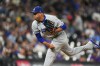 Los Angeles Dodgers relief pitcher Edwin DÌaz works against the Colorado Rockies in the ninth inning of a baseball game Monday, Aug. 17, 2026, in Denver. (AP Photo/David Zalubowski)
