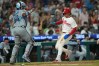 Philadelphia Phillies' Bryson Stott, scores past Miami Marlins catcher Brian Navarreto, on an RBI single by Kyle Schwarber, during the eighth inning of a baseball game, Tuesday, Aug. 18, 2026, in Philadelphia. (AP Photo/Matt Rourke)