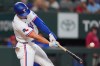 Texas Rangers' Justin Foscue launches a solo home run during the second inning of a baseball game against the Washington Nationals, Tuesday, Aug. 18, 2026, in Arlington, Texas. (AP Photo/LM Otero)