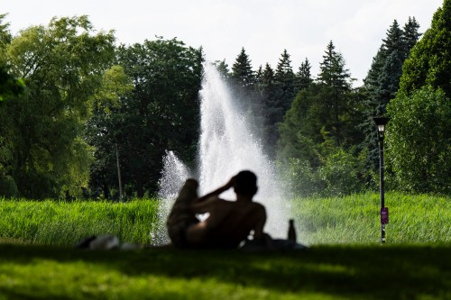 A man takes shelter under a tree on a hot day in Montreal on Thursday, July 2, 2026. THE CANADIAN PRESS/Christopher Katsarov