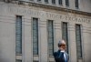 A man walks past a building in Toronto that used to house the Toronto Stock Exchange on Thursday, Aug. 18, 2011. THE CANADIAN PRESS/Aaron Vincent Elkaim