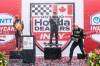 Marcus Ericsson, of Sweden, centre, celebrates after winning the 2026 Honda Indy with second-place Romain Grosjean, of Switzerland, left, and third-place Will Power, of Australia, in Markham, Ont., on Sunday, Aug. 16, 2026. THE CANADIAN PRESS/Keito Newman