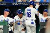 Kansas City Royals' John Rave (16) celebrates in the dugout after scoring on a single by Miakel Garcia during the eighth inning of a baseball game against the Athletics, Wednesday, Aug. 19, 2026, in Kansas City, Mo. (AP Photo/Charlie Riedel)