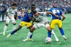 Houston Dynamo FC's Guilherme Santos, centre, Vancouver Whitecaps' Cheikh, left, and Andres Cubas, right, vie for the ball during the first half of an MLS soccer match in Vancouver, B.C., on Wednesday, August 19, 2026. THE CANADIAN PRESS/Ethan Cairns