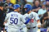Los Angeles Dodgers' Miguel Rojas, right, congratulates Mookie Betts as he crosses home plate after hitting a solo home run off Colorado Rockies starting pitcher Kyle Freeland in the fourth inning of a baseball game Wednesday, Aug. 19, 2026, in Denver. (AP Photo/David Zalubowski)