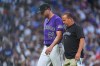 Colorado Rockies starting pitcher Kyle Freeland, back, is escorted to the clubhouse by trainer Heath Townsend after Freeland was pulled from the mound because of injury in the fourth inning of a baseball game against the Los Angeles Dodgers Wednesday, Aug. 19, 2026, in Denver. (AP Photo/David Zalubowski)