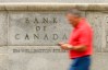 A man checks his phone as he walks past the Bank of Canada building in Ottawa, Wednesday, July 15, 2026. THE CANADIAN PRESS/Adrian Wyld