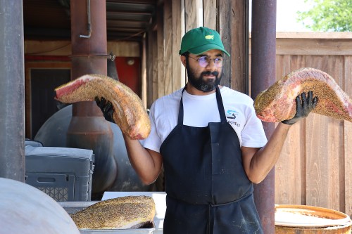 Zain Shafi prepares to put briskets in the smoker at Goldee's BBQ, Saturday, June 27, 2026, in Fort Worth, Texas. (Fiona André/Religion News Service via AP)