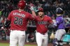 Arizona Diamondbacks' Ketel Marte celebrates with Nolan Arenado (28) after hitting a solo home run against the Colorado Rockies in the first inning of a baseball game, Tuesday, Aug. 11, 2026, in Phoenix. (AP Photo/Rick Scuteri)