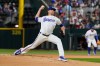 Texas Rangers pitcher Jacob deGrom throws and strikes out Washington Nationals' Abimelec Ortiz, his 2000th career strikeout, in the first inning of a baseball game Thursday, Aug. 20, 2026, in Arlington, Texas. (AP Photo/Tony Gutierrez)