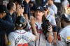 Atlanta Braves pitcher Grant Holmes high-fives teammates in the dugout after being relieved in the seventh inning of a baseball game against the Chicago White Sox, Thursday, Aug. 20, 2026, in Chicago. (AP Photo/Matt Marton)
