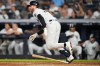 New York Yankees' Ryan McMahon follows through on a two-run single during the seventh inning of a baseball game Tuesday, Aug. 11, 2026, in New York. (AP Photo/Frank Franklin II)