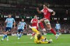 Arsenal's Riccardo Calafiori leaps over Coventry City's goalkeeper Carl Rushworth during the English Premier League soccer match between Arsenal and Coventry City in London, Friday, Aug. 21, 2026. (AP Photo/Kirsty Wigglesworth)