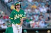 Athletics' Jacob Wilson reacts after being hit by a pitch during an at-bat in the first inning of a baseball game against the Texas Rangers Friday, Aug. 14, 2026, in West Sacramento, Calif. (AP Photo/Sara Nevis)
