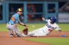 Los Angeles Dodgers' Andy Pages, right, steals second as Milwaukee Brewers second baseman David Hamilton has his glove knocked off while trying to catch the throw from home during the XX inning of a baseball game Friday, Aug. 14, 2026, in Los Angeles. (AP Photo/Mark J. Terrill)