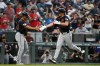 Cleveland Guardians third base coach Rouglas Odor, left, celebrates with Petey Halpin, right, as Halpin rounds the bases on a solo home run in the third inning of a baseball game against the Colorado Rockies, Friday, Aug. 21, 2026, in Denver. (AP Photo/Geneva Heffernan)