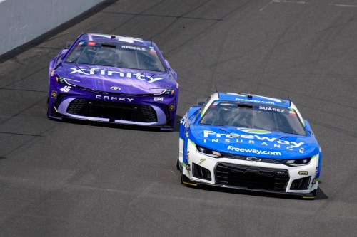 Daniel Suarez (7) leads Tyler Reddick (45) into the first turn during a NASCAR Cup Series auto race at Indianapolis Motor Speedway in Indianapolis, Sunday, July 26, 2026. (AP Photo/Michael Conroy)
