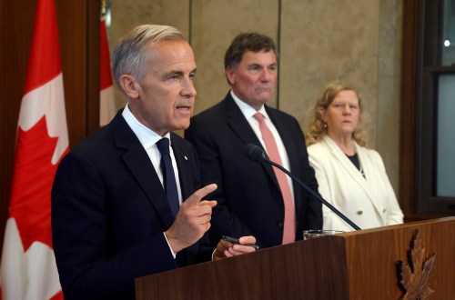 Prime Minister Mark Carney speaks about Canada's response to new U.S. tariffs as Canada-U.S. Trade Minister Dominic LeBlanc and chief trade negotiator Janice Charette listen during a news conference on Parliament Hill in Ottawa on Saturday, Aug. 22, 2026. THE CANADIAN PRESS/Patrick Doyle
